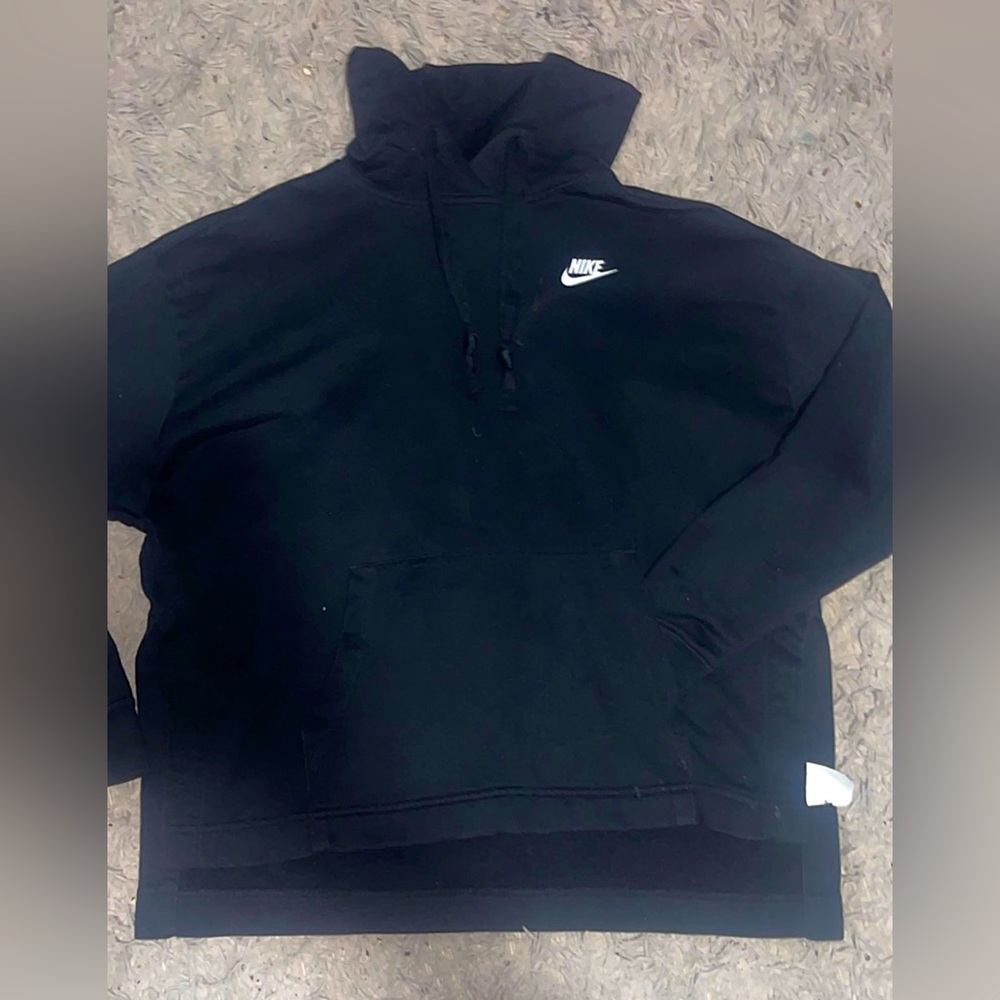Black Nike hoodie. Loose fitting. Slits on each side. Short in front.